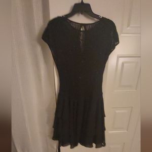 Black Beaded Cocktail Dress Size 10,short sleeves with flutter bottom.